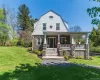 A picturesque 1930s residence featuring a stone porch that serves as a cool, shaded sanctuary. A picturesque 1930s residence featuring a stone porch that serves as a cool, shaded sanctuary.