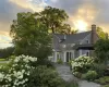 View of front of home featuring a chimney and a shingled roof View of front of home featuring a chimney and a shingled roof
