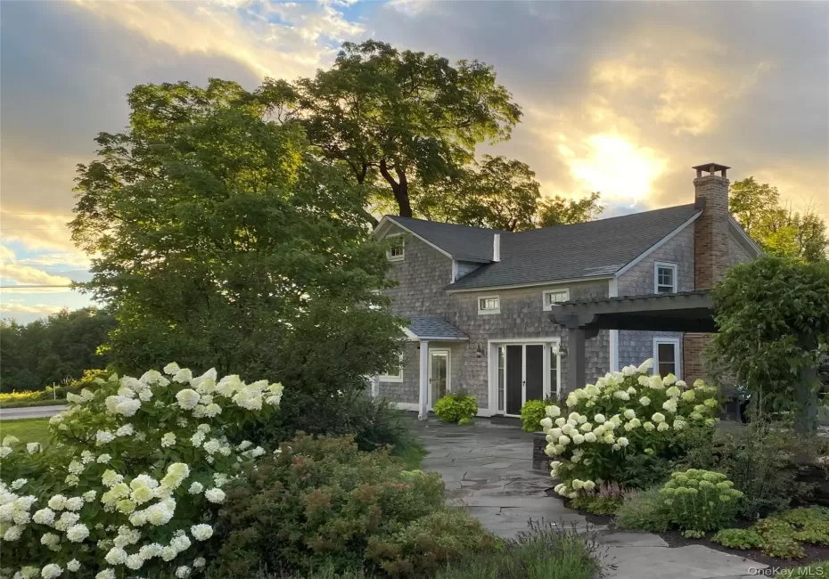 View of front of home featuring a chimney and a shingled roof View of front of home featuring a chimney and a shingled roof