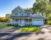 View of front facade featuring a porch, driveway, roof with shingles, a front lawn, and an attached garage View of front facade featuring a porch, driveway, roof with shingles, a front lawn, and an attached garage