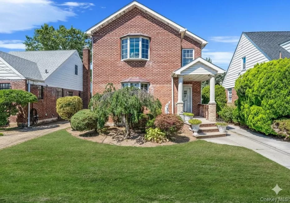 View of front of home with a front lawn and brick siding View of front of home with a front lawn and brick siding