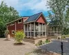 The Warwick Model. View of home's exterior with a metal roof, a standing seam roof, and covered porch The Warwick Model. View of home's exterior with a metal roof, a standing seam roof, and covered porch