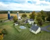 Close up of back of farm with barns, main house, pool area Close up of back of farm with barns, main house, pool area