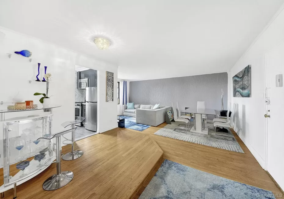 Large and open living room with an elevated dining area that leads to the kitchen. Hardwood floors throughout. Large and open living room with an elevated dining area that leads to the kitchen. Hardwood floors throughout.