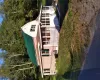 View of front of house with a porch, a gambrel roof, a front lawn, and a metal roof View of front of house with a porch, a gambrel roof, a front lawn, and a metal roof