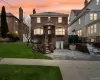View of front of home with brick siding, driveway, and a chimney View of front of home with brick siding, driveway, and a chimney