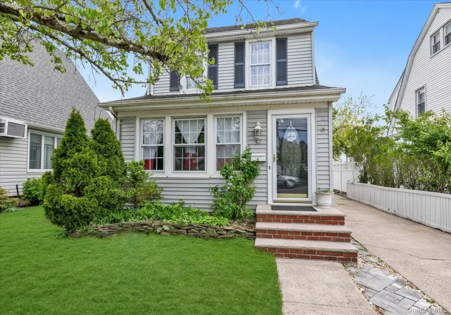 Charming WP Chalet Colonial Light gray siding exterior with black shutters and a front entry door with a full-view glass insert Charming WP Chalet Colonial Light gray siding exterior with black shutters and a front entry door with a full-view glass insert