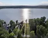 Expansive lake frontage with a cleared building site, mature trees, and direct road access Expansive lake frontage with a cleared building site, mature trees, and direct road access
