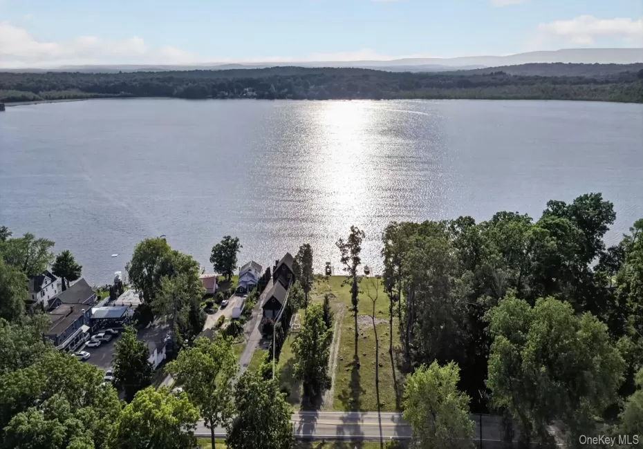 Expansive lake frontage with a cleared building site, mature trees, and direct road access Expansive lake frontage with a cleared building site, mature trees, and direct road access