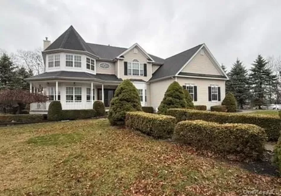 View of front of property with a porch, a chimney, and a front lawn View of front of property with a porch, a chimney, and a front lawn