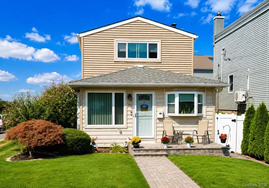 Colonial featuring light-toned horizontal siding and a gabled roof Colonial featuring light-toned horizontal siding and a gabled roof