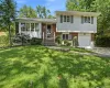 Split-level residence featuring a brick and white siding facade with a single-car garage Split-level residence featuring a brick and white siding facade with a single-car garage