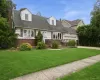 Traditional style residence featuring a brick and siding facade with dormer windows Traditional style residence featuring a brick and siding facade with dormer windows
