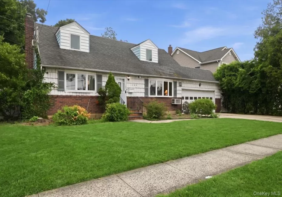 Traditional style residence featuring a brick and siding facade with dormer windows Traditional style residence featuring a brick and siding facade with dormer windows