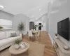 Open-concept living space featuring vaulted ceilings and wood-finish flooring Open-concept living space featuring vaulted ceilings and wood-finish flooring