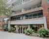 Brick facade building featuring multiple balconies with metal railings Brick facade building featuring multiple balconies with metal railings