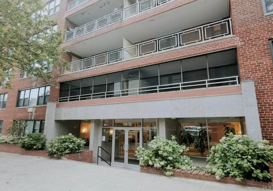Brick facade building featuring multiple balconies with metal railings Brick facade building featuring multiple balconies with metal railings