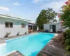 Outdoor pool with a patio area, a deck, and outdoor dining space Outdoor pool with a patio area, a deck, and outdoor dining space