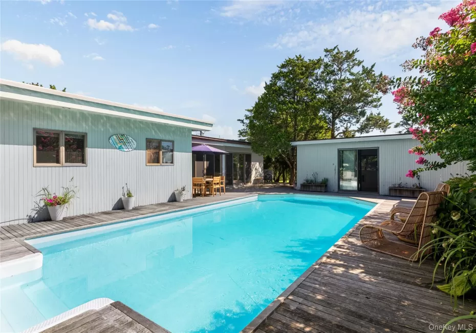 Outdoor pool with a patio area, a deck, and outdoor dining space Outdoor pool with a patio area, a deck, and outdoor dining space