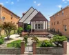 Tudor-style residence with a distinct gabled roofline and a brick and stucco exterior Tudor-style residence with a distinct gabled roofline and a brick and stucco exterior