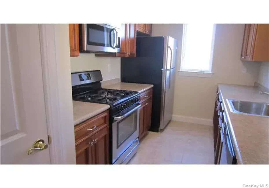 Beautiful kitchen with lots of wood cabinets, counter space, stainless steel appliances and pantry Beautiful kitchen with lots of wood cabinets, counter space, stainless steel appliances and pantry