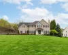 Traditional style residence featuring a broad front lawn Traditional style residence featuring a broad front lawn