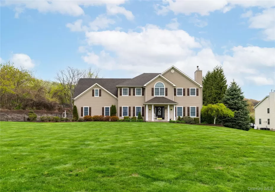 Traditional style residence featuring a broad front lawn Traditional style residence featuring a broad front lawn