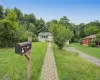 Spacious front yard with a long private driveway and peaceful surroundings. Spacious front yard with a long private driveway and peaceful surroundings.