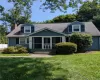 Two-story rental features dormer windows, a screened-in front porch, and a sidewalk entrance Two-story rental features dormer windows, a screened-in front porch, and a sidewalk entrance