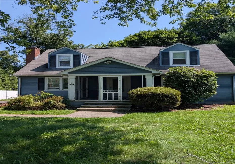 Two-story rental features dormer windows, a screened-in front porch, and a sidewalk entrance Two-story rental features dormer windows, a screened-in front porch, and a sidewalk entrance
