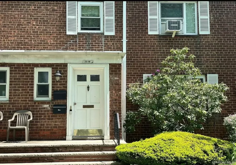 Brick facade residence featuring white framed windows with shutters Brick facade residence featuring white framed windows with shutters