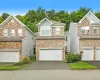 Multi-story townhome with a stone and siding exterior Multi-story townhome with a stone and siding exterior
