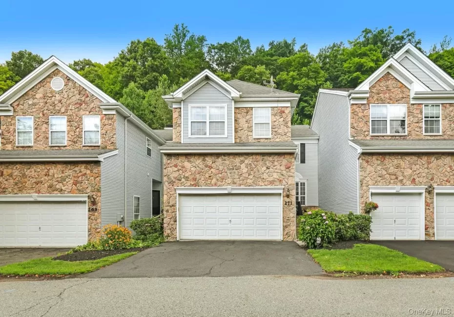 Multi-story townhome with a stone and siding exterior Multi-story townhome with a stone and siding exterior