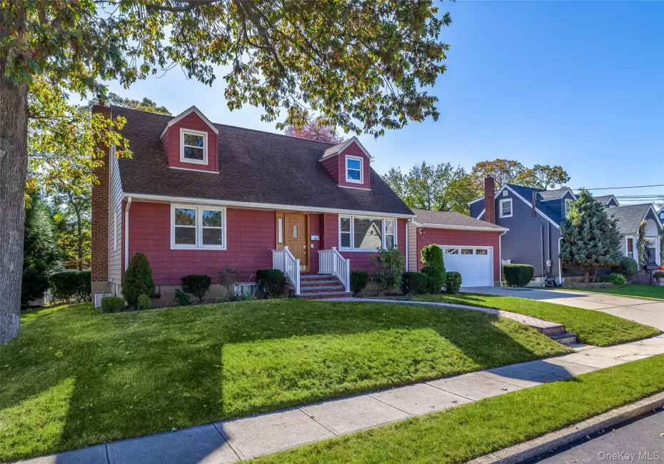 Rear dormered Cape with two car detached garage Rear dormered Cape with two car detached garage