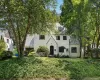 Tudor-style house featuring a high end roof and stucco siding Tudor-style house featuring a high end roof and stucco siding