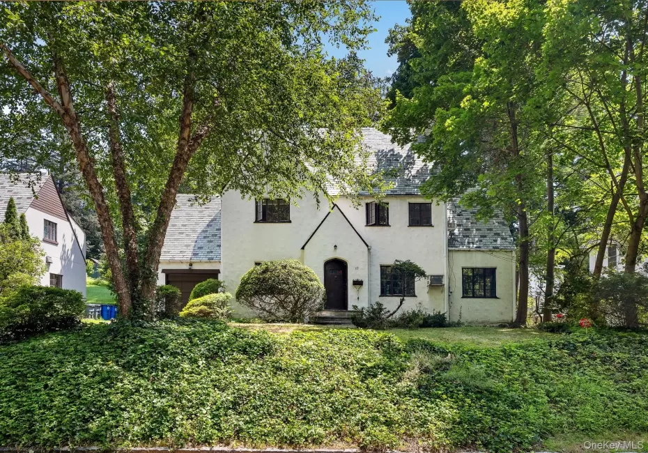 Tudor-style house featuring a high end roof and stucco siding Tudor-style house featuring a high end roof and stucco siding