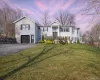 Raised ranch with driveway, a front lawn, and a garage Raised ranch with driveway, a front lawn, and a garage