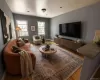 Living area featuring wood-finish flooring, recessed lighting, and two double-hung windows Living area featuring wood-finish flooring, recessed lighting, and two double-hung windows