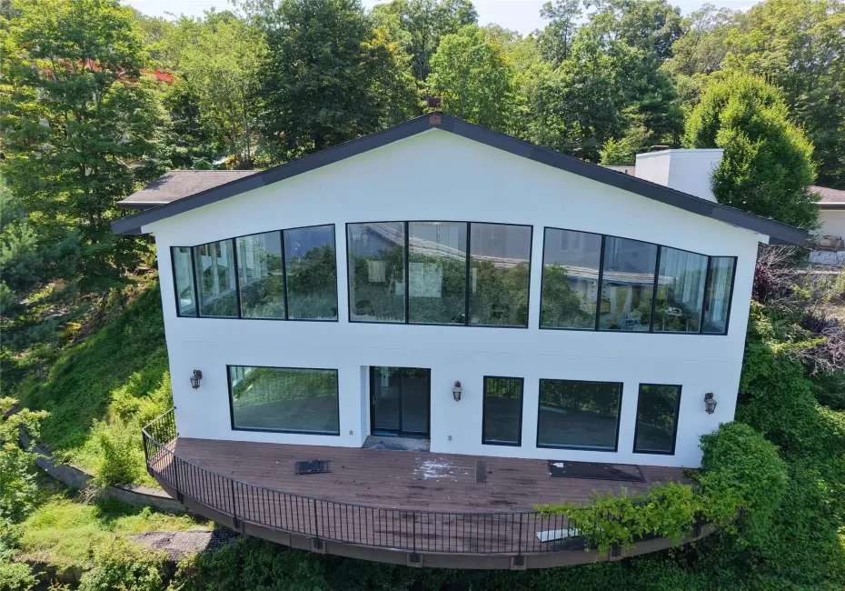 Modern home with stucco siding and a deck Modern home with stucco siding and a deck