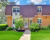 Brick and white siding exterior with a gambrel roofline Brick and white siding exterior with a gambrel roofline