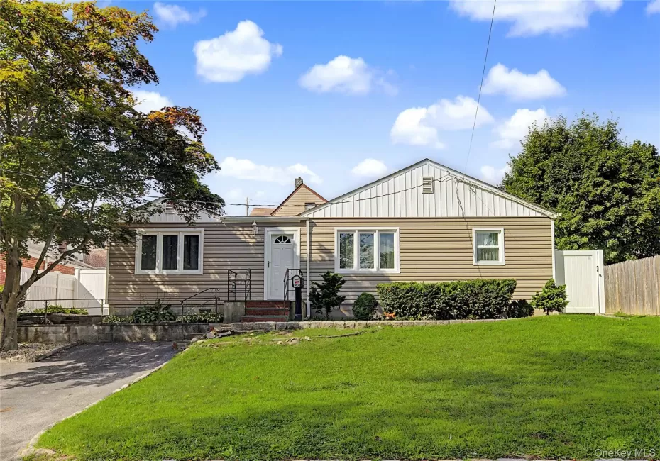 Charming ranch-style home featuring a gabled roof with metal accents, horizontal siding exterior, and a welcoming front entrance Charming ranch-style home featuring a gabled roof with metal accents, horizontal siding exterior, and a welcoming front entrance
