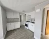 Kitchen featuring white cabinetry, a gas range, a single basin sink, and tile flooring granit countertops. Kitchen featuring white cabinetry, a gas range, a single basin sink, and tile flooring granit countertops.