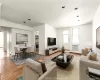 Spacious living and dining area featuring hardwood flooring, recessed lighting, and crown molding. Spacious living and dining area featuring hardwood flooring, recessed lighting, and crown molding.