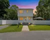 White clapboard exterior with an arched entry door White clapboard exterior with an arched entry door