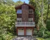 Split-level exterior featuring wood siding, balcony, and shake accents Split-level exterior featuring wood siding, balcony, and shake accents