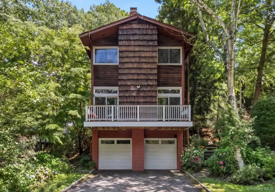 Split-level exterior featuring wood siding, balcony, and shake accents Split-level exterior featuring wood siding, balcony, and shake accents