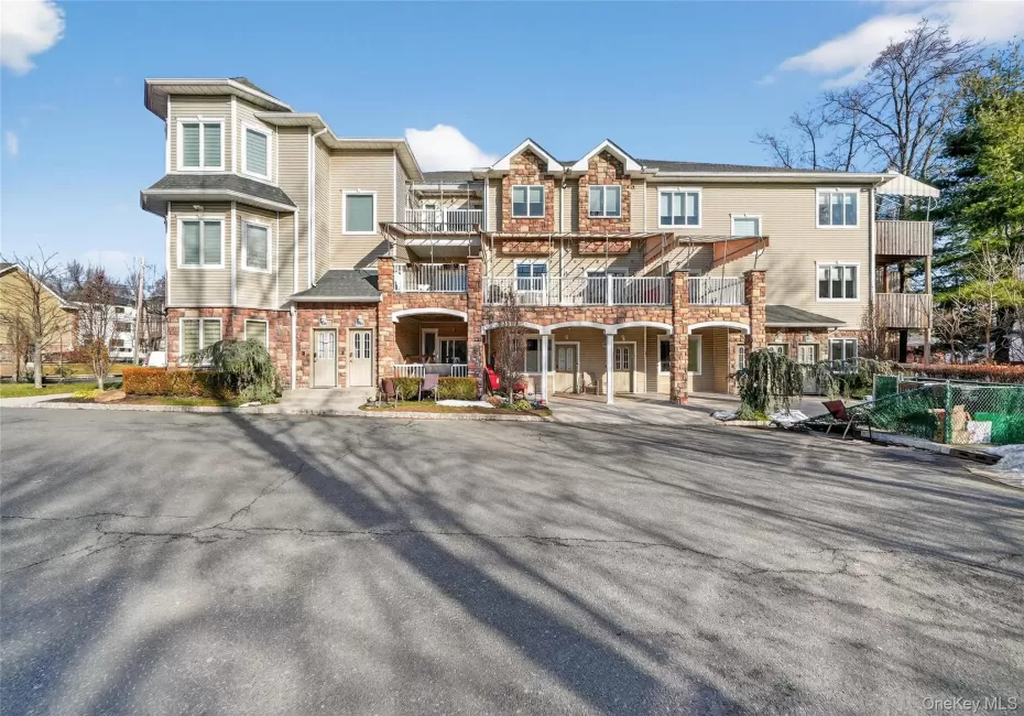 View of front of property featuring a balcony and stone siding View of front of property featuring a balcony and stone siding