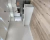 Modern kitchen featuring white shaker cabinetry, stainless steel appliances, and a central island with a sink Modern kitchen featuring white shaker cabinetry, stainless steel appliances, and a central island with a sink