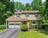Split-level home featuring a two-car garage with overhead doors Split-level home featuring a two-car garage with overhead doors