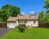 Cape Cod style residence featuring dormer windows, a single-car garage, and a paved driveway Cape Cod style residence featuring dormer windows, a single-car garage, and a paved driveway